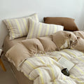 Butter yellow striped duvet cover set with matching pillowcases, striped fabric bedding.