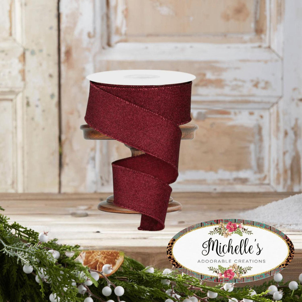 Burgundy fine glitter ribbon spool with ribbon wrapped in a wide loop
