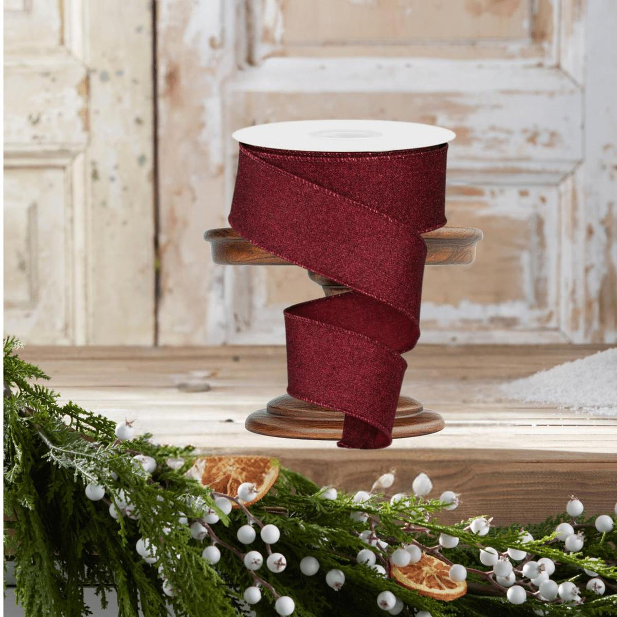 Burgundy glitter ribbon spool with cascading wide ribbon on display