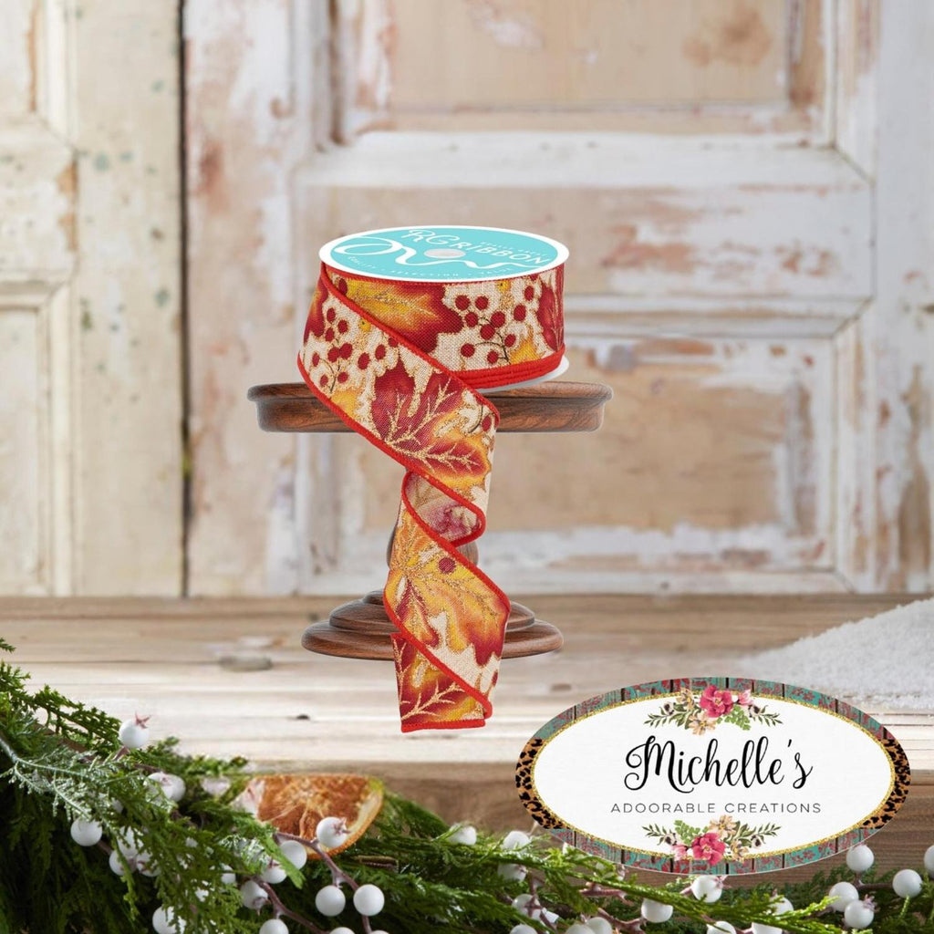 1.5-inch decorative ribbon with red berries and gold leaves, spool with draped ribbon
