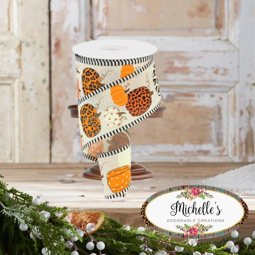 Cream ribbon with orange pumpkins, leopard spots, and black-and-white stripe border.