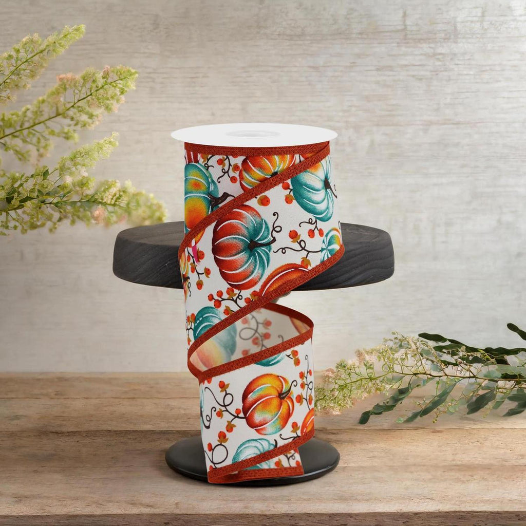 Ivory ribbon roll with pumpkin floral print and teal-and-orange ribbon edging