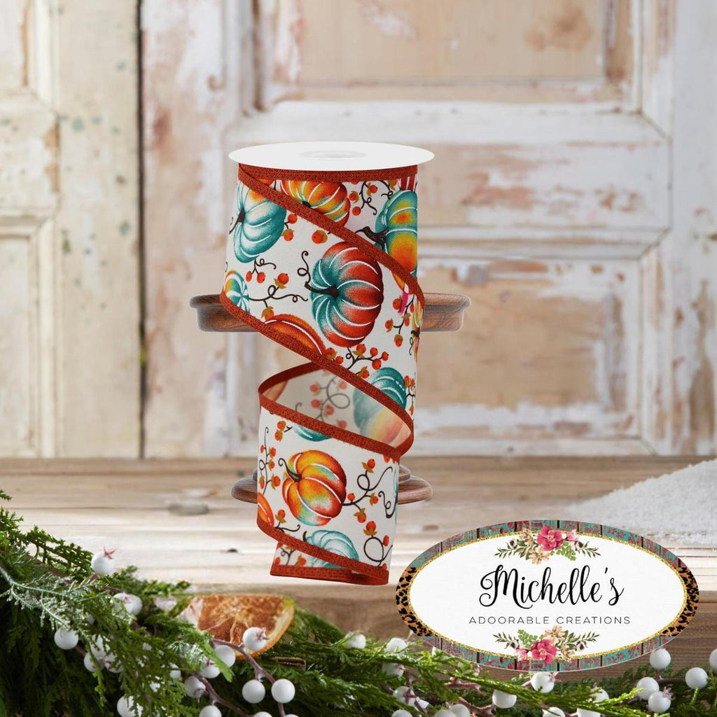 Ivory ribbon roll with large pumpkin illustrations and teal swirls, orange ribbon band