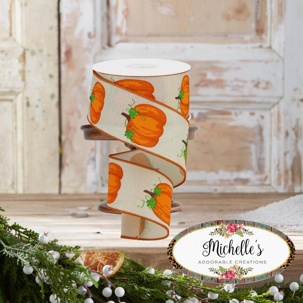 Cream pumpkin ribbon on a spool, orange pumpkins with green vine accents