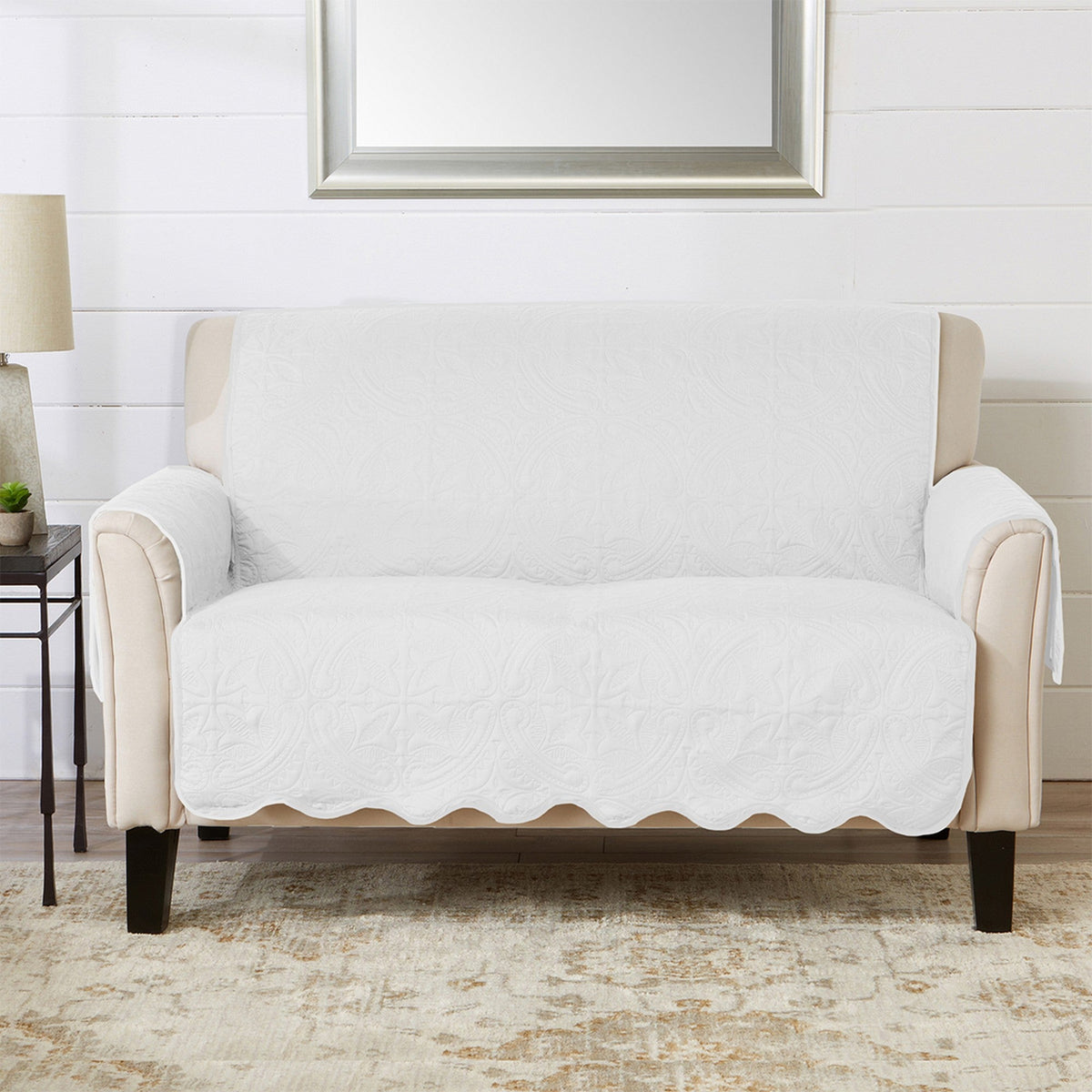 White loveseat protector draped over sofa-style chair, covering seat and arms