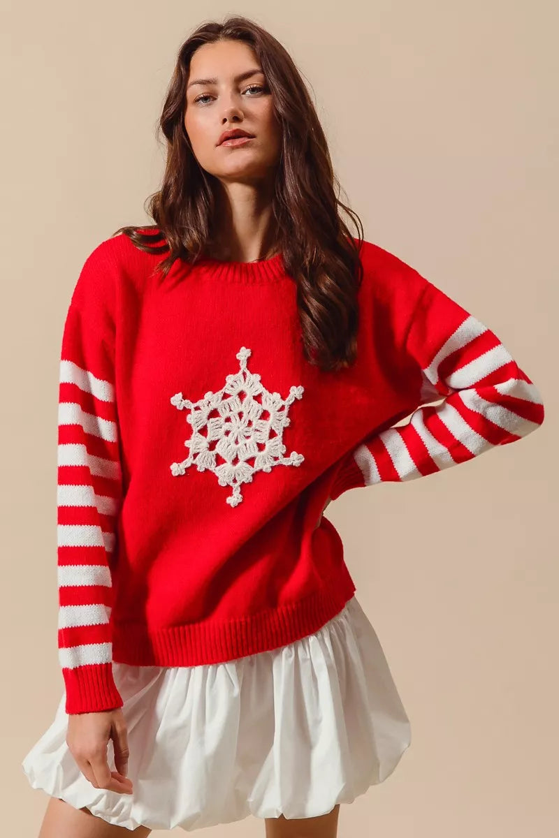Red Christmas knit sweater with white crochet snowflake front and striped red sleeves