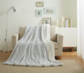 Light blue faux fur throw blanket draped over couch