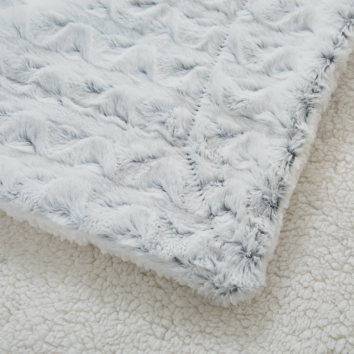 Light blue faux fur throw blanket with cream backing corner