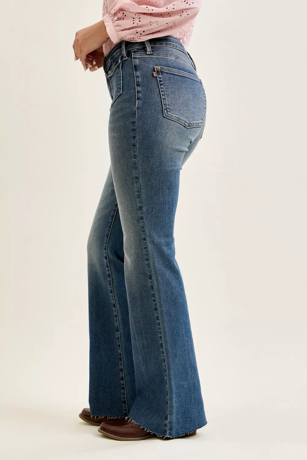 Mid-rise blue flare jeans with front flap pockets and wide flared leg opening