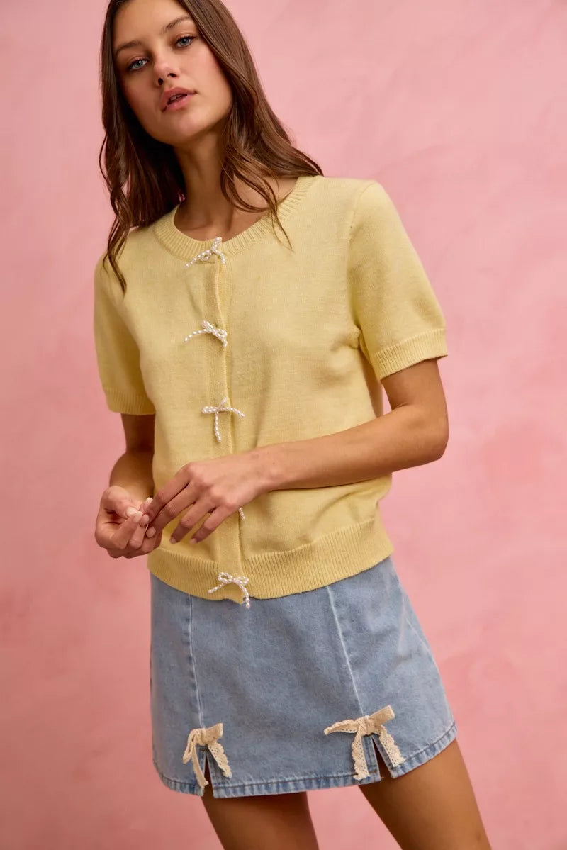 Denim mini skirt with lace ribbon bow accents at the hem