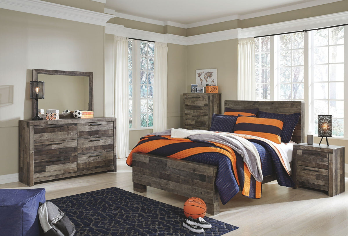 Youth panel bedroom set with gray bed, dresser with mirror, two nightstands, and accent pillows