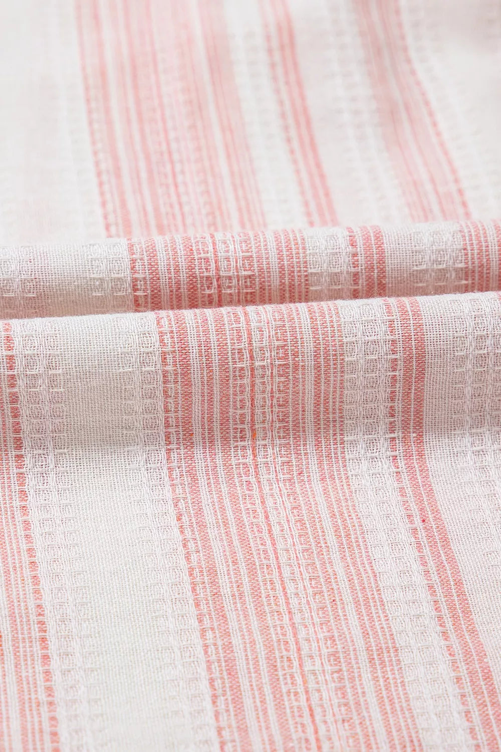 Close-up of dusty pink striped fabric with fine vertical texture