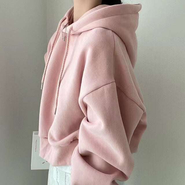 Women's hooded sweater, loose fit, light pink pullover with hood and drawstrings, side view