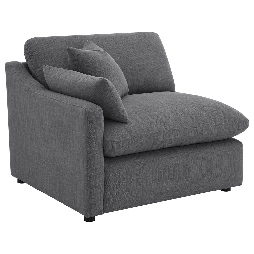 Charcoal upholstered chaise-style sectional with square arms and two accent pillows