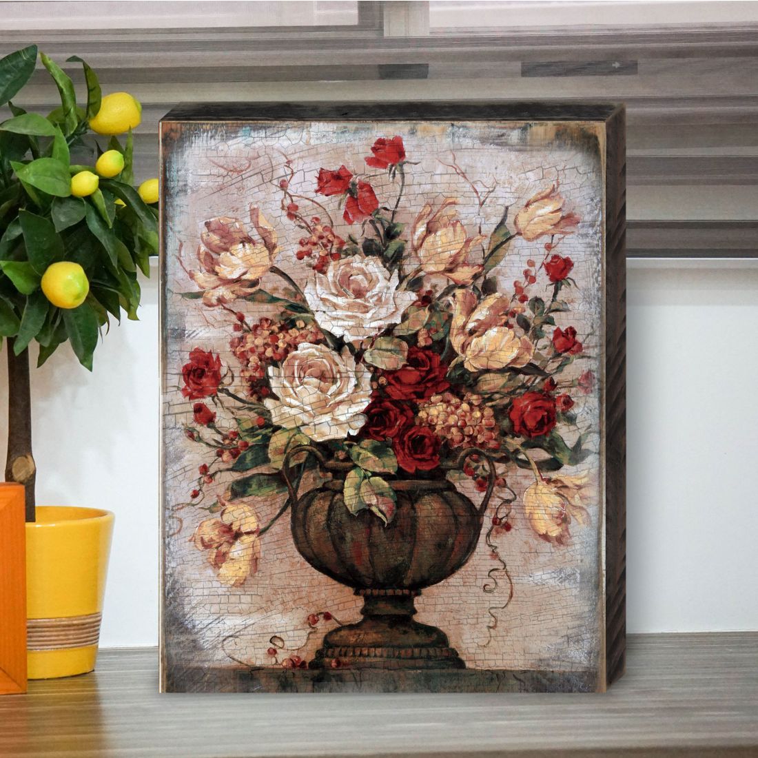 Wooden wall art featuring floral bouquet in urn vase, red and cream blooms
