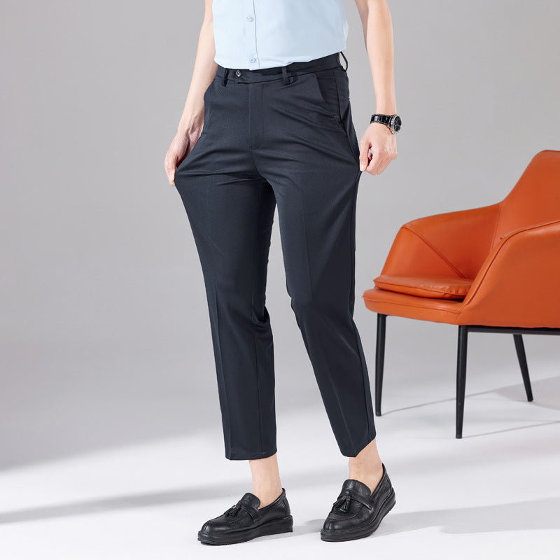 Navy blue tailored trousers, high waist, belt loops, and straight tapered silhouette