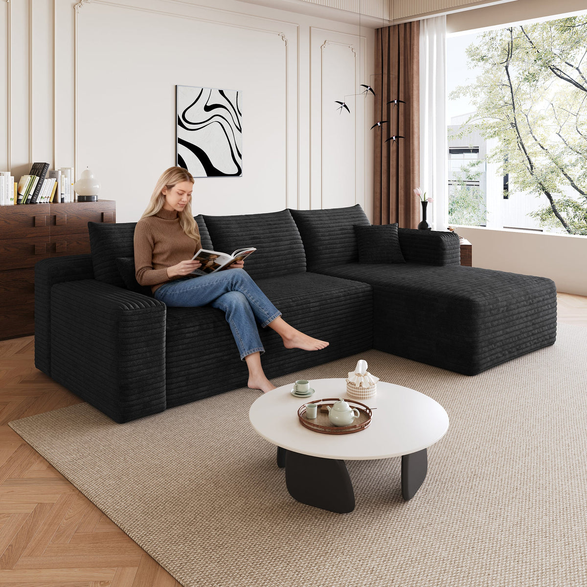 Black corduroy sectional sofa with chaise, wide armrests and square back cushions