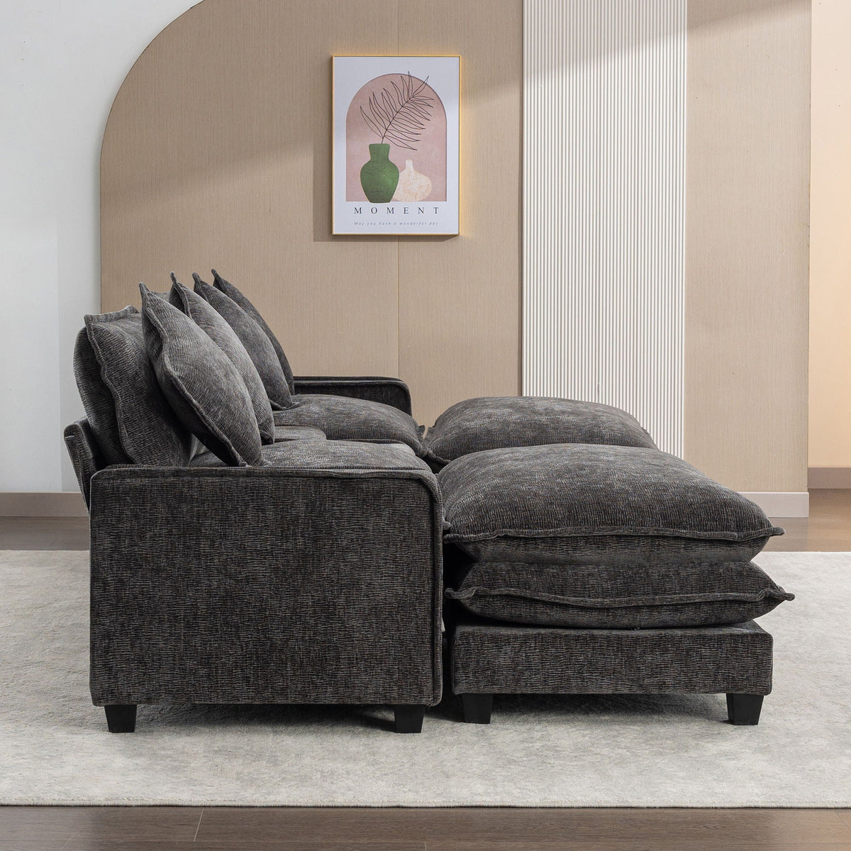 Dark gray sectional sofa with two large ottomans and square throw pillows