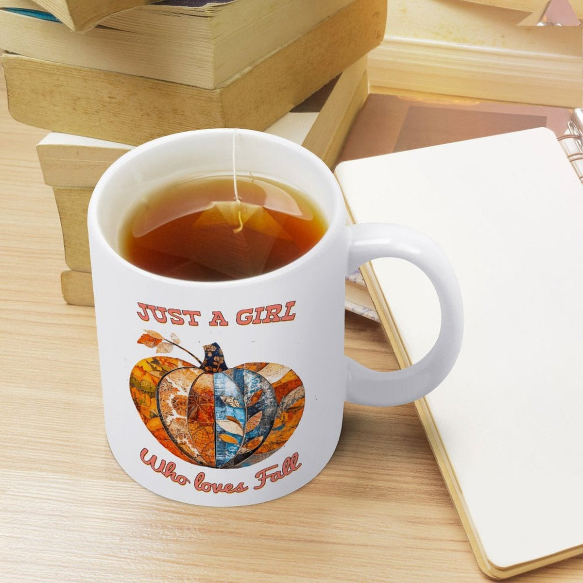 White ceramic mug with handle, pumpkin graphic, filled with tea
