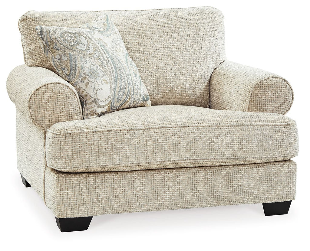 Sandstone upholstered chair with patterned throw pillow and rounded arms