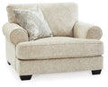 Sandstone upholstered chair with patterned throw pillow and rounded arms