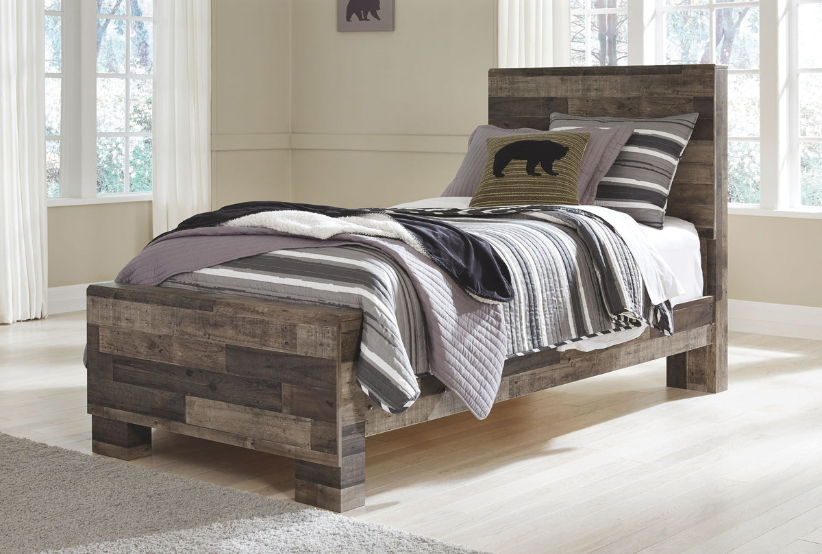 Youth panel bed with dark wood footboard and layered striped bedding