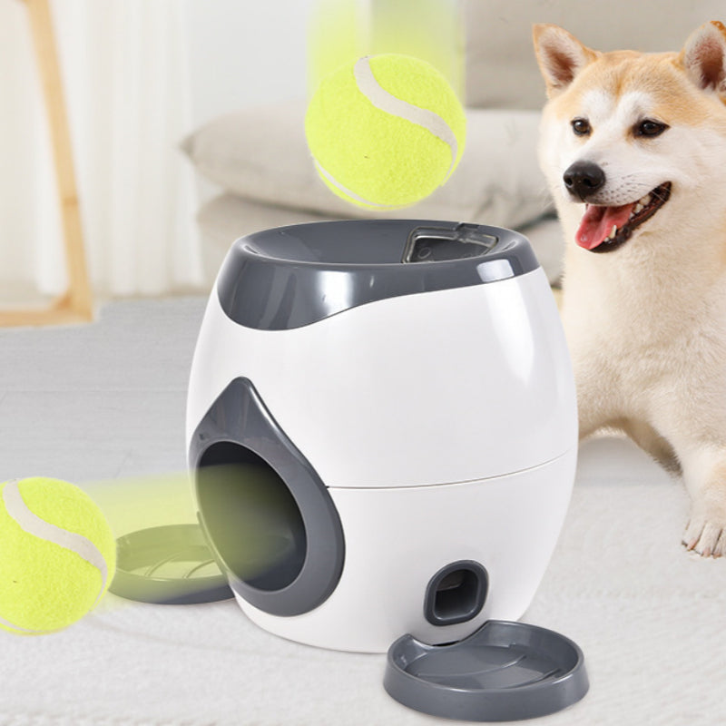 White and gray smart pet feeder with side ball launcher and tennis balls accessory