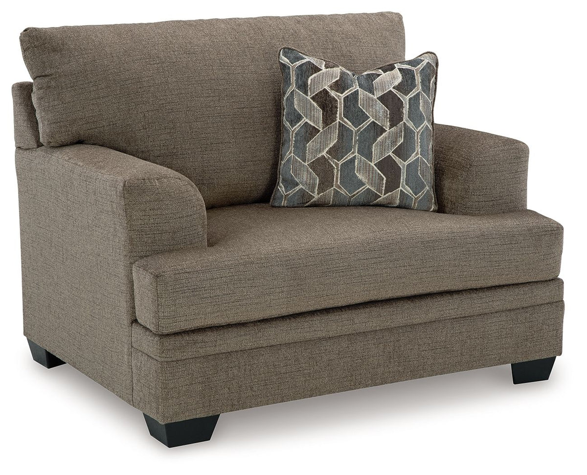 Brown accent loveseat with rolled arms and geometric throw pillow on seat