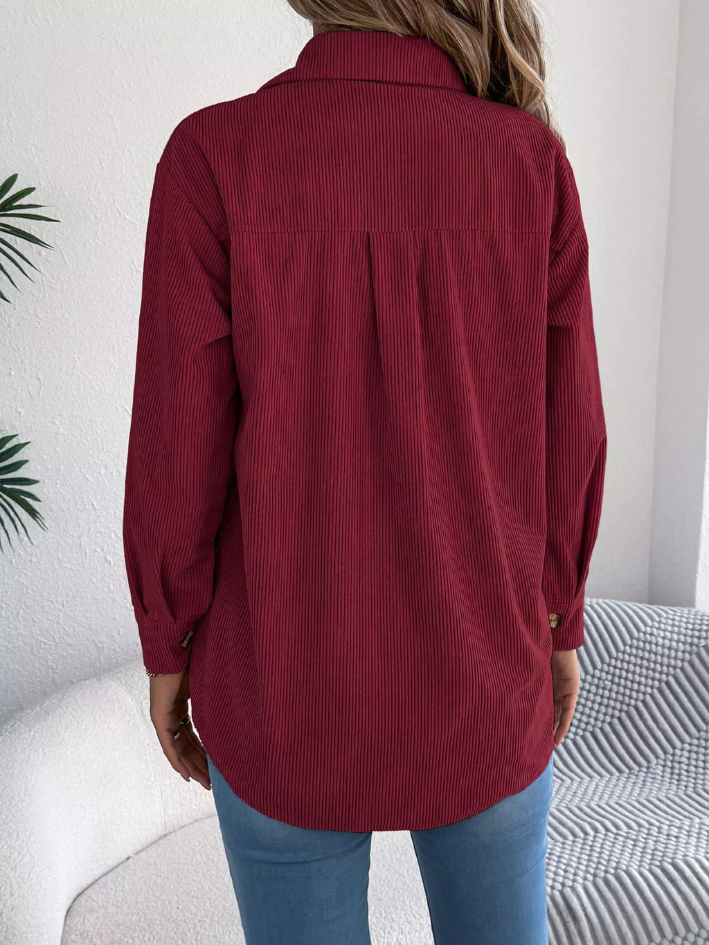 Back view of wine red corduroy shacket with curved hem and button cuffs