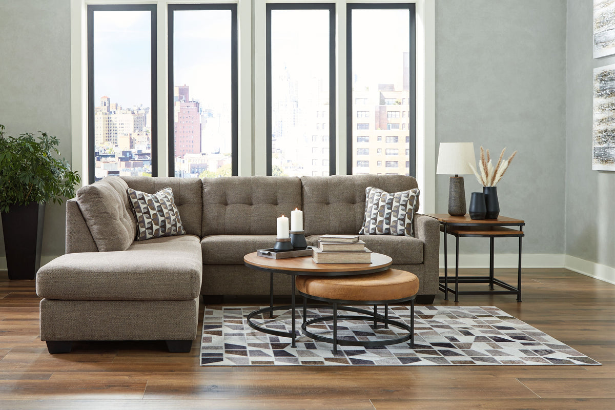 Light gray corner chaise sectional with chaise extension and patterned throw pillows