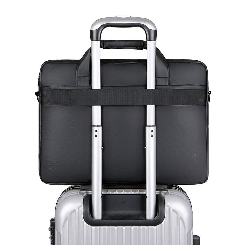 Black waterproof laptop briefcase bag with trolley sleeve over rolling suitcase