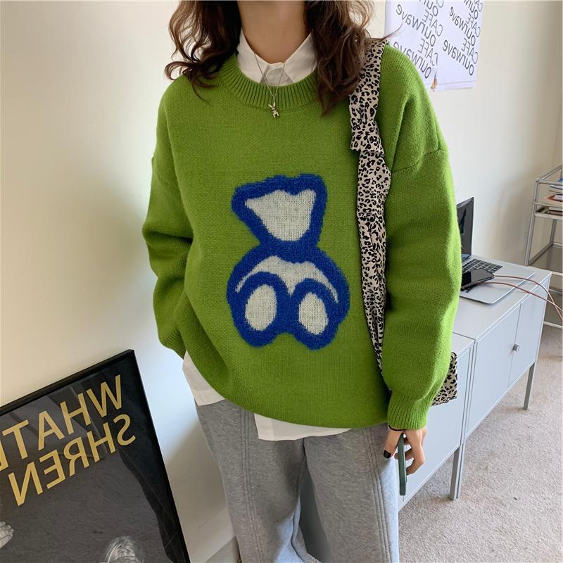 Women’s green knit sweater with long sleeves and blue abstract heart graphic