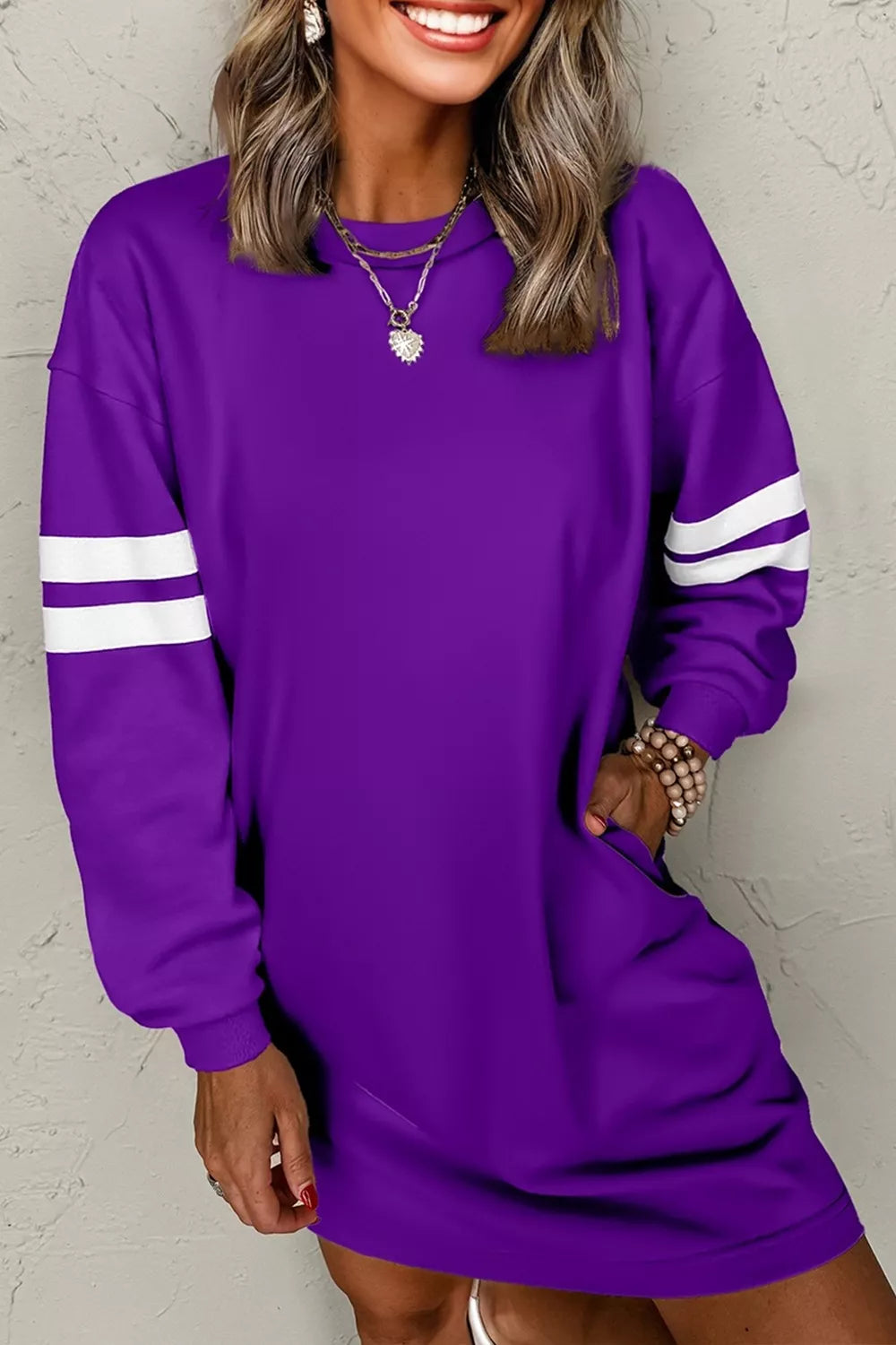 Purple long-sleeve sweatshirt dress with white striped cuffs and relaxed fit.