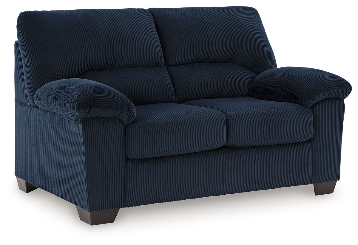 Blue upholstered sofa with track arms and padded back cushions
