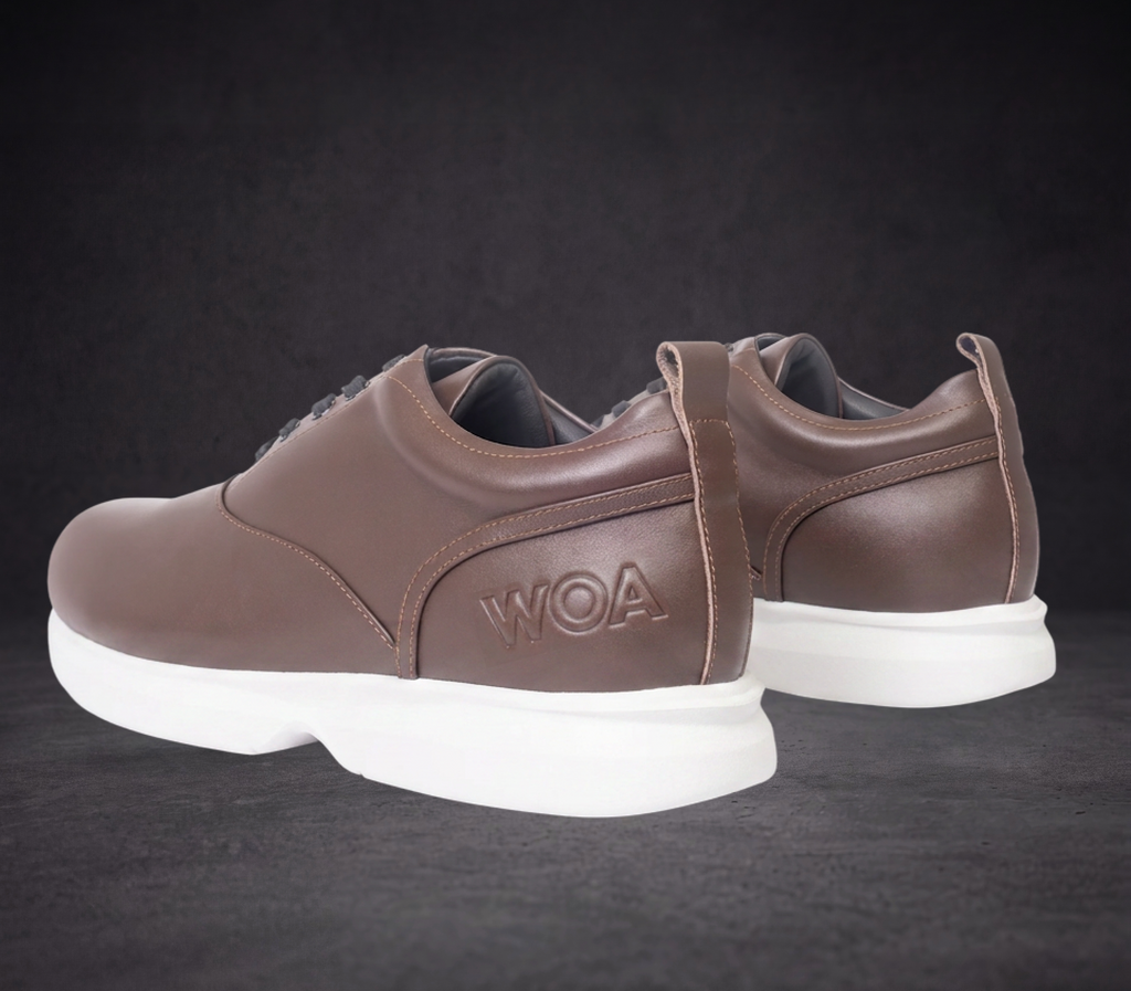 WOA brown low-top sneaker rear three-quarter view with pull tab and white sole