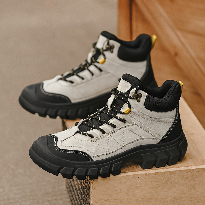 Two white and black high-top hiking boots with lace-up and chunky tread sole