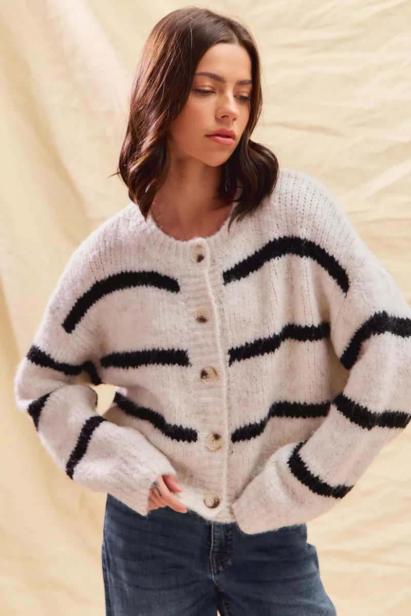 Button-front knit cardigan sweater with wide black stripe bands on cream base