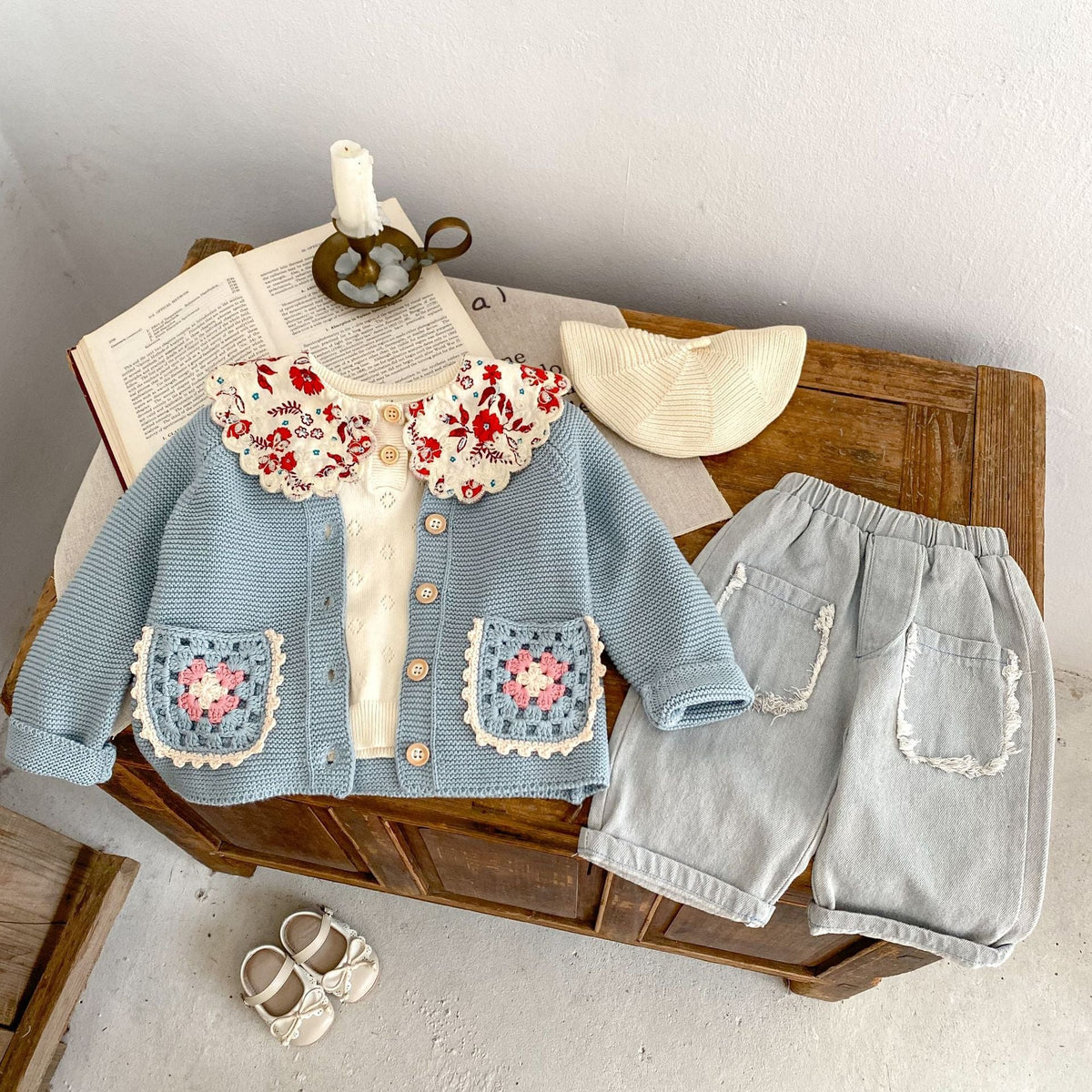 Smokey blue knit cardigan with round collar, button front, crochet flower pocket squares