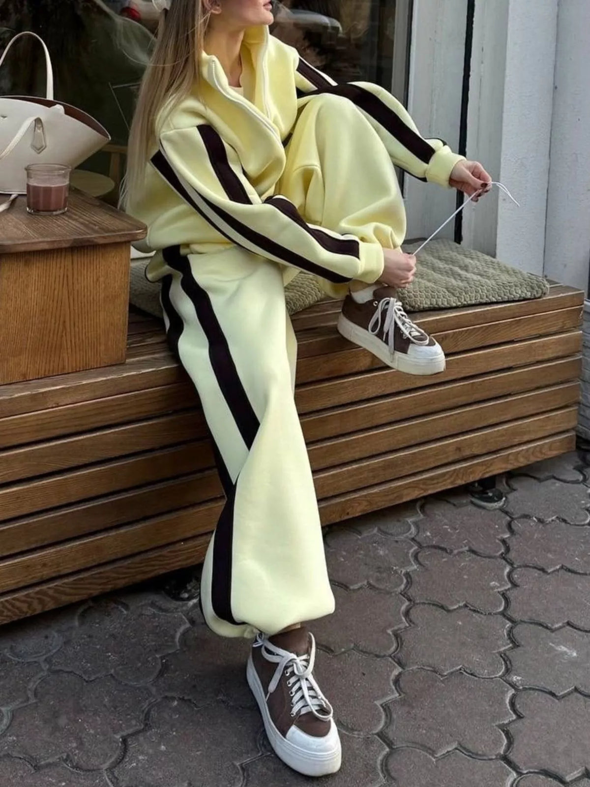 Light yellow tracksuit set with black-and-cream contrast stripes and zip jacket