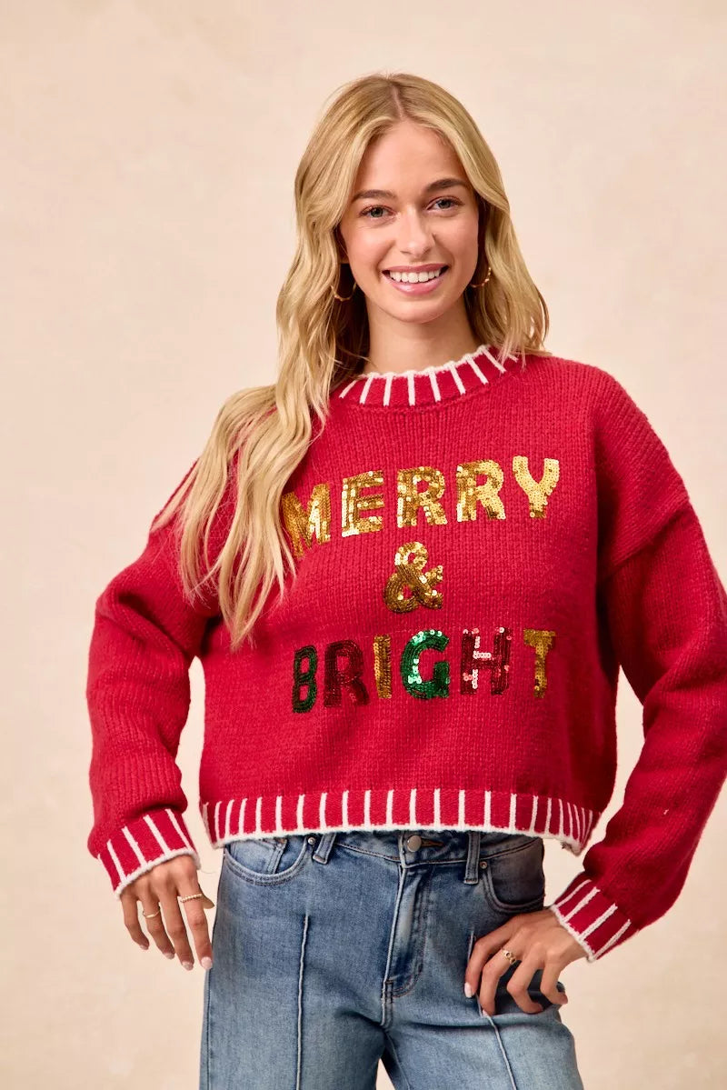 Red sequin “MERRY & BRIGHT” sweater with ribbed striped collar, cuffs, and hem