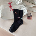 Children's black ribbed socks with dog embroidery and red/blue stripe on cuff