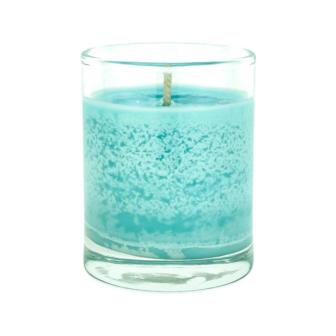 Teal soy candle in clear glass jar with visible wick