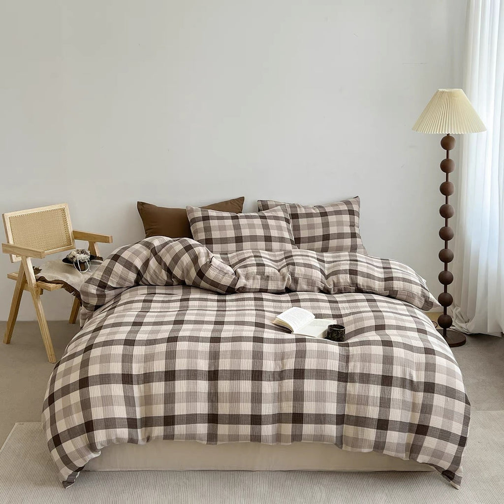 Brown-and-gray plaid duvet cover set with two pillow shams on a neatly made bed.