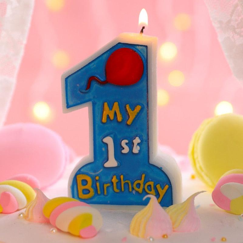 Blue "My 1st Birthday" number 1 candle topper surrounded by candy-like decor