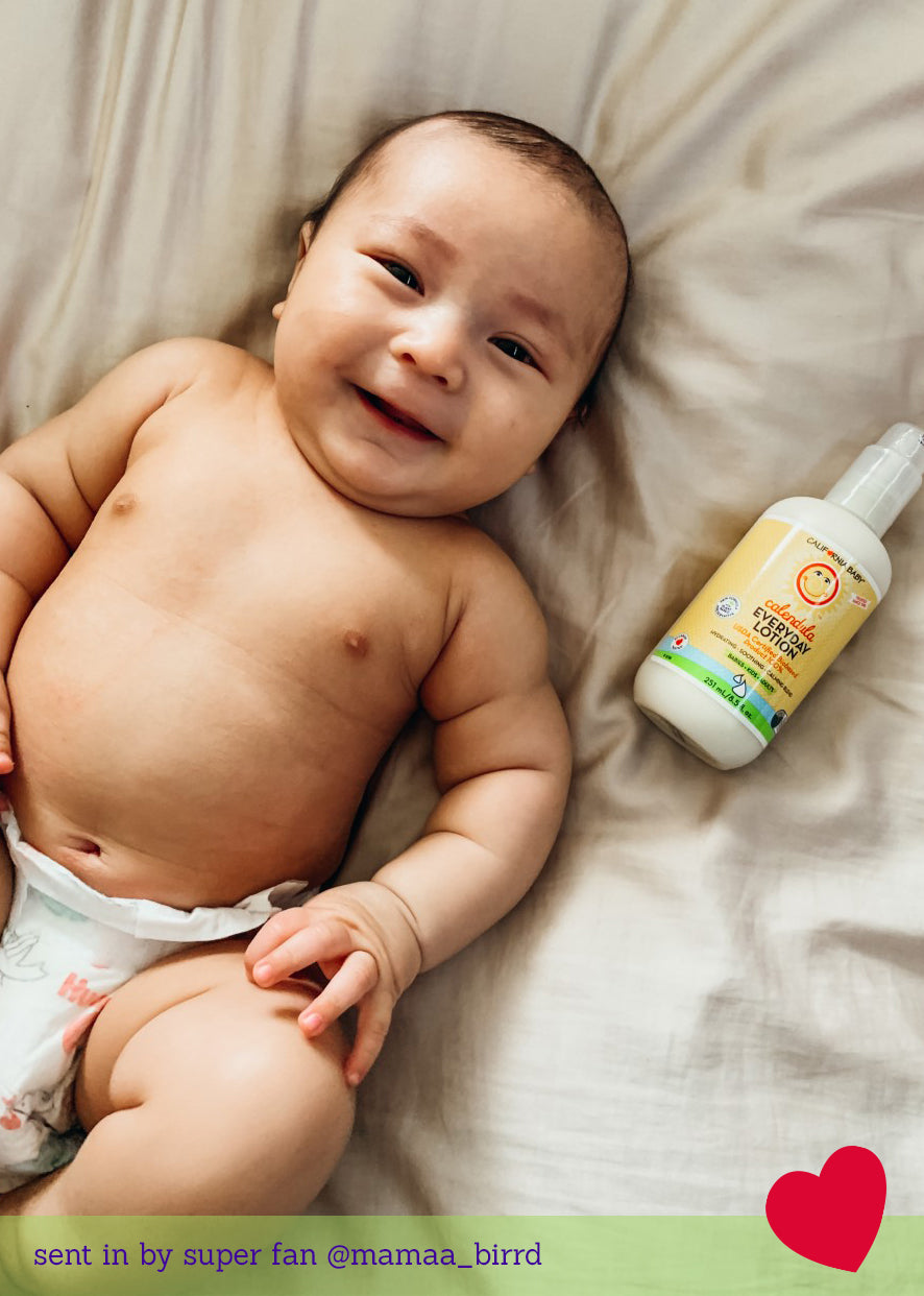 Calendula Everyday Lotion pump bottle beside a smiling baby