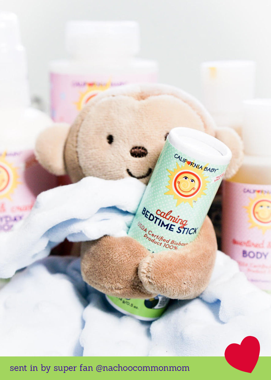 Calming Bedtime Stick tube held by a plush teddy bear