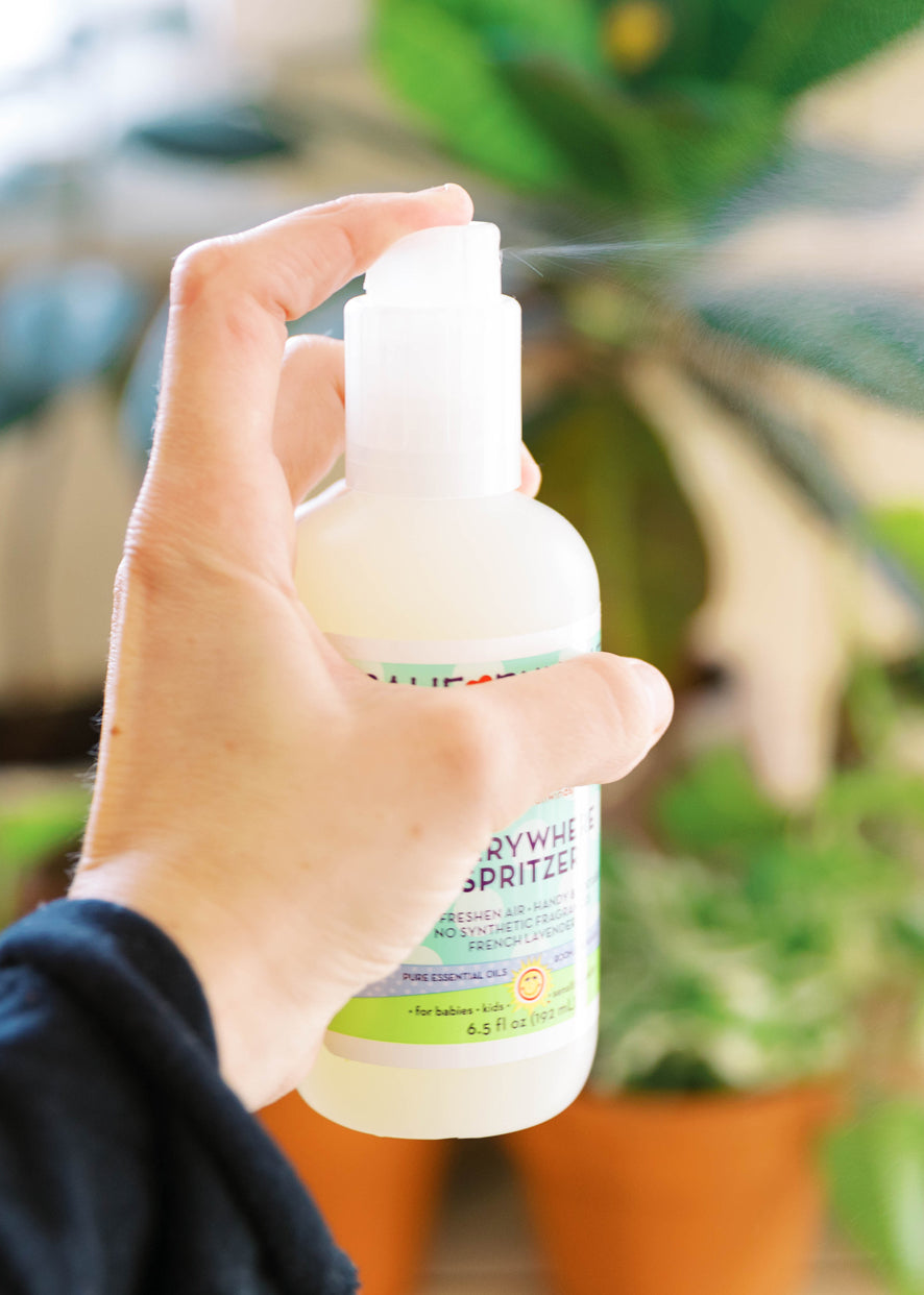 Spritzer bottle with white pump held in hand, calming label visible