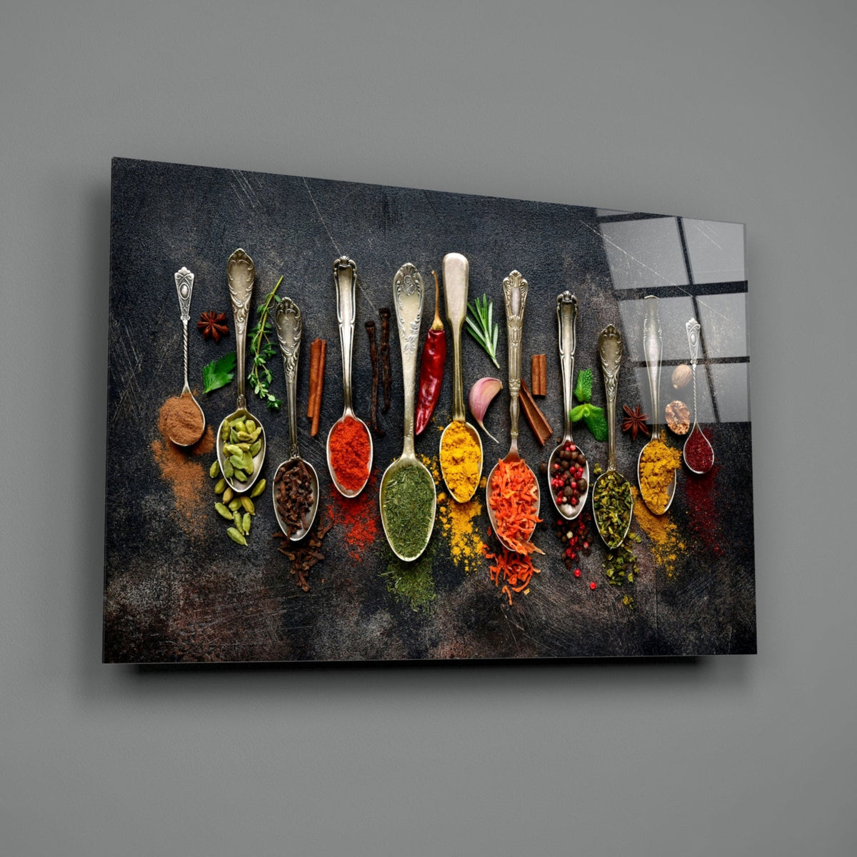 Rectangular glass wall art of a row of colorful spice spoons with mixed textures