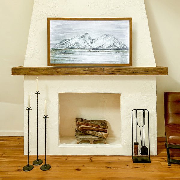 Three tall black metal floor candle holders standing together with round candle cup tops.