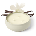 White 3-wick candle in round jar, three flames visible, with orchid flowers